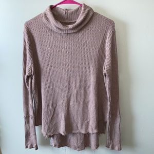 Distressed turtleneck sweater.